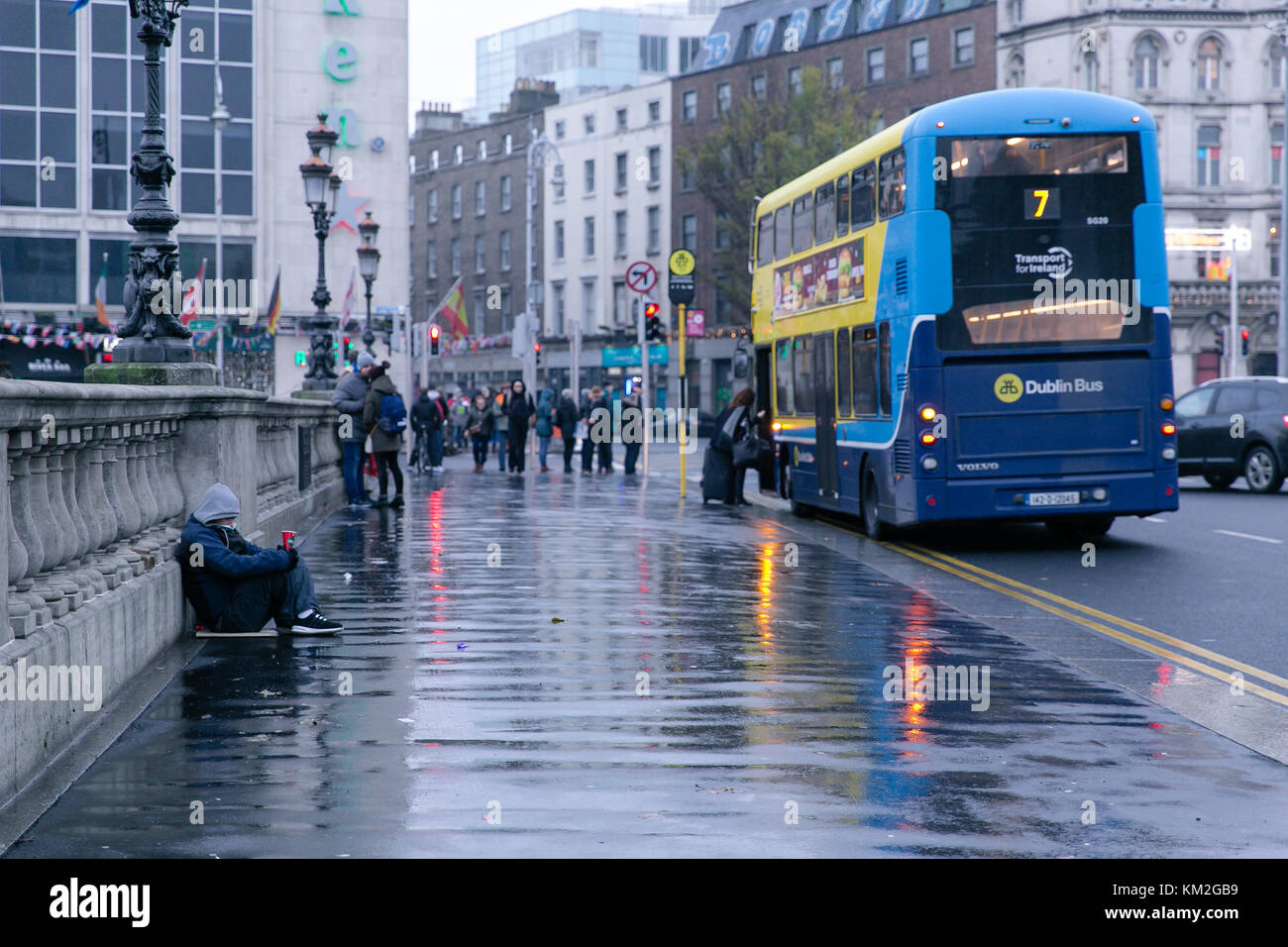 Dublin, Ireland. 3rd Dec, 2017. Homeless man begging on O`Connell bridge in Dublin on a rainy December day Stock Photo